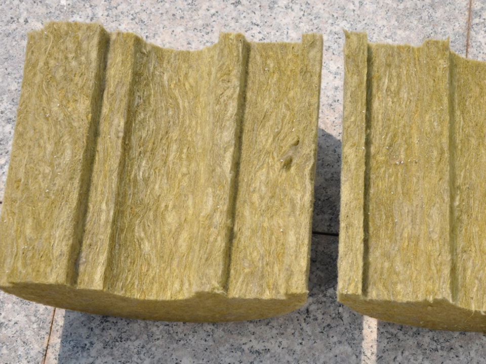 Pre-slit stone wool pipe section opened to show longitudinal slit